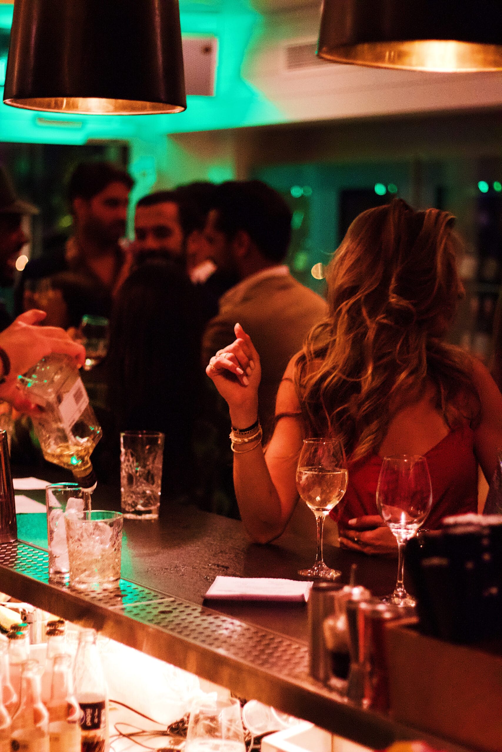 People socializing at a bar with drinks