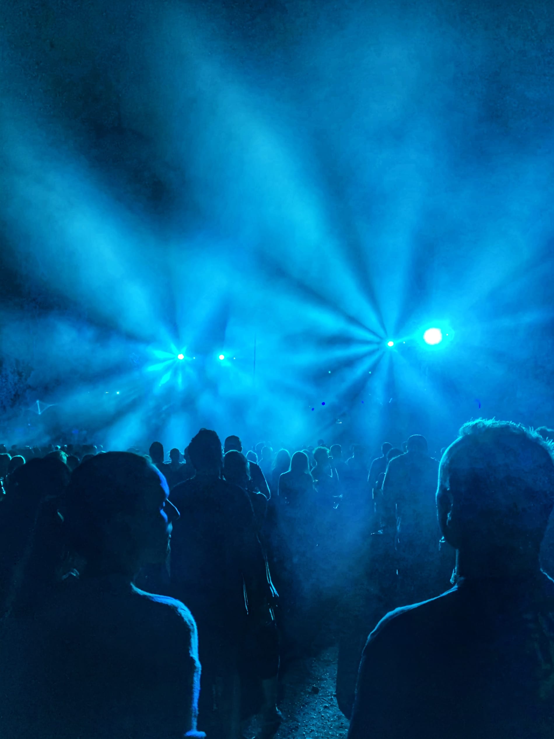 Crowd at concert with blue stage lights