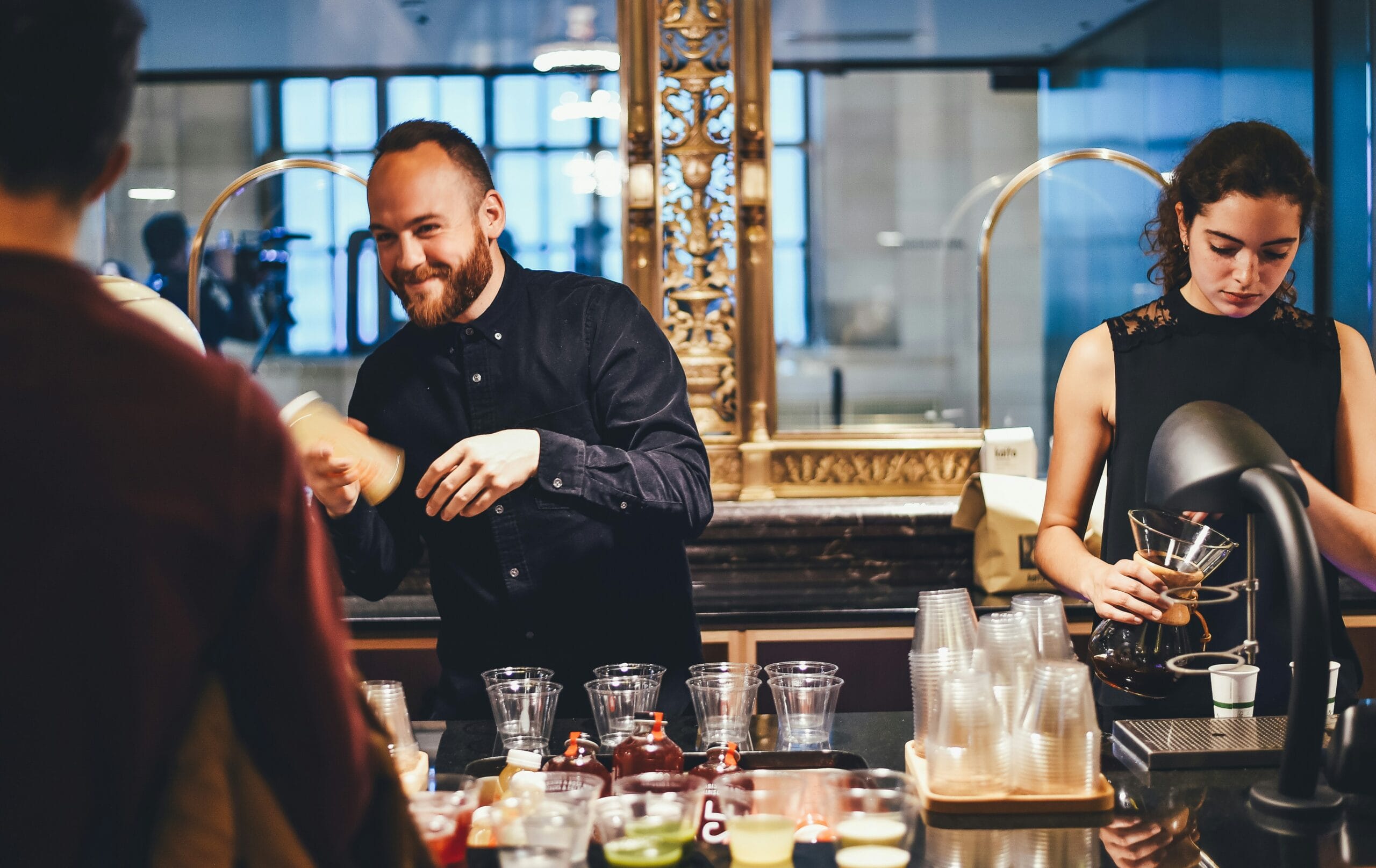 Bartenders preparing drinks in a stylish bar.